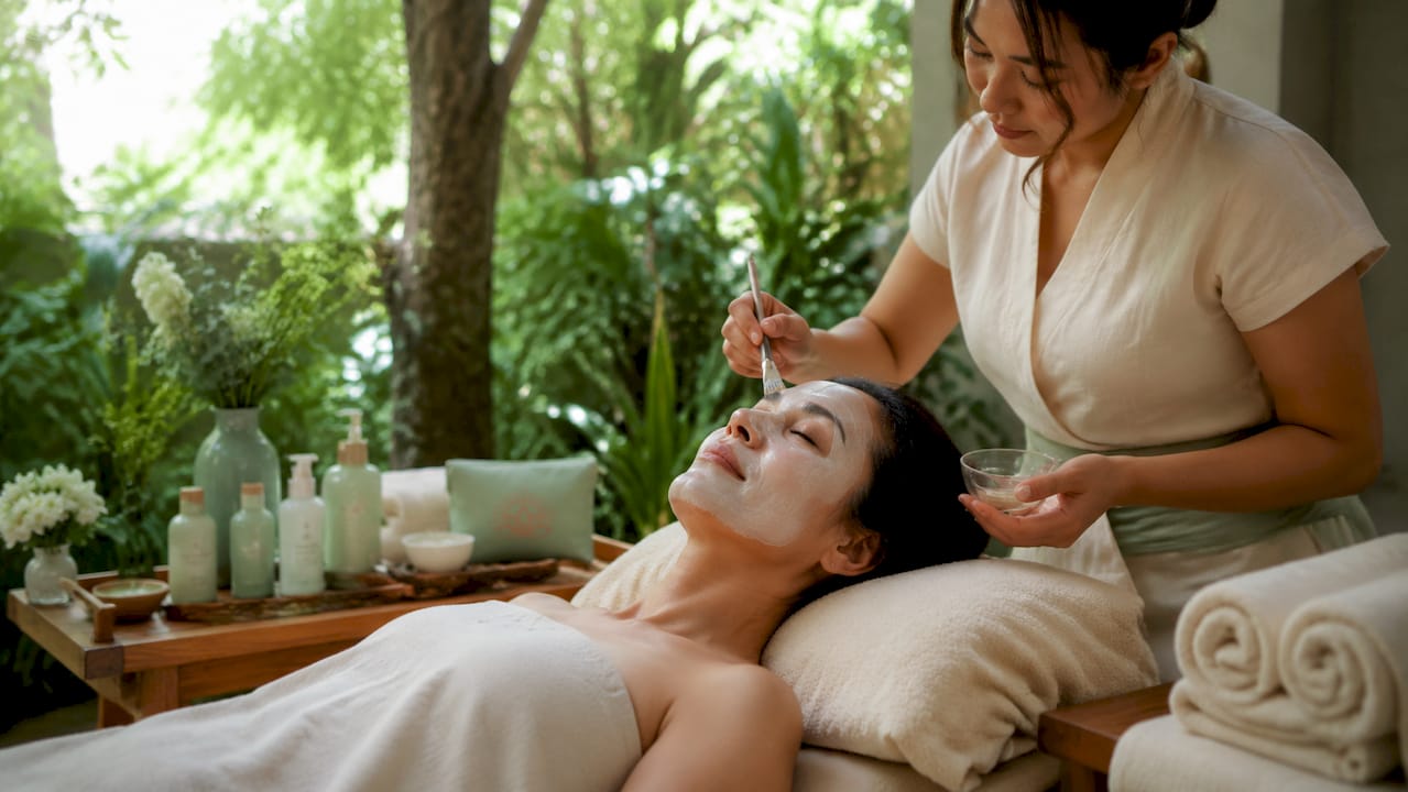 Woman receiving hydrating facial in spa treatment room